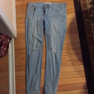 Intentionally distressed light wash jeans